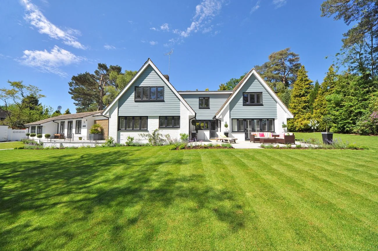 White gabled home with a broad lawn, shown as exterior inspiration
